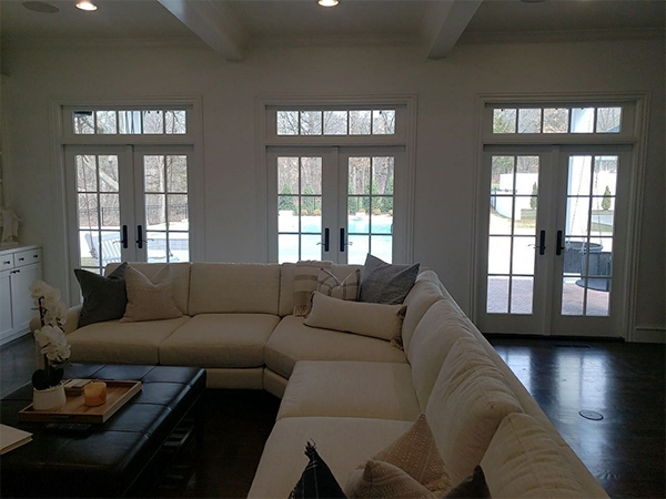 three sets of hinged doors in a dark room with little light