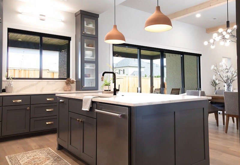 contemporary kitchen in Tulsa with black cupboards, windows and sliding patio doors