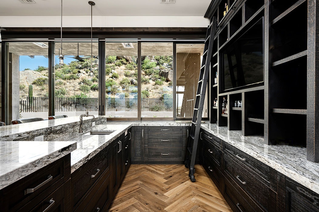 Interior of a Scottsdale modern home kitchen highlighting closed sliding patio doors.