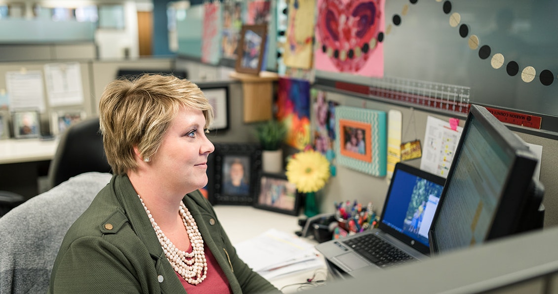 pella employee working in her desk area well decorated