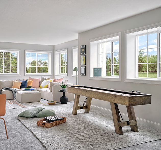 family room interior with a game table and several vinyl sliding windows on each wall
