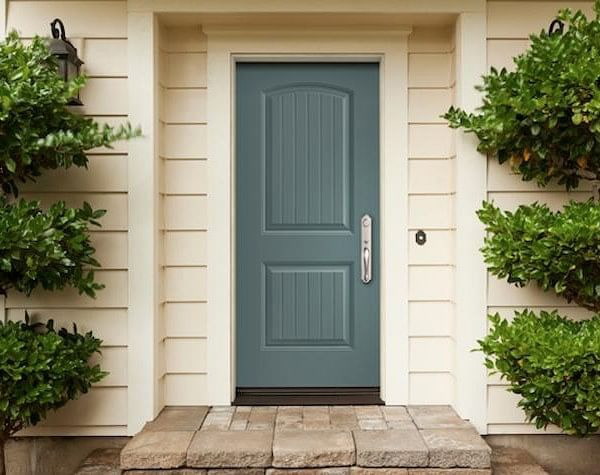 A blue-hued solid fiberglass front door as viewed from the exterior.