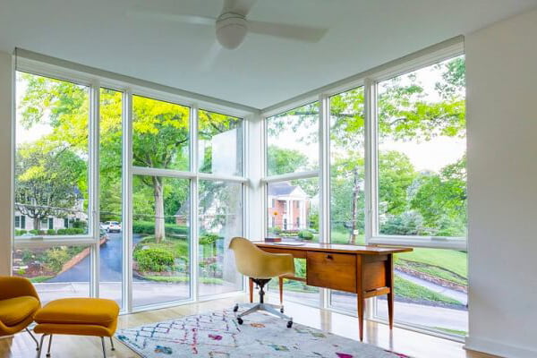Floor to ceiling windows on both walls of a corner home office