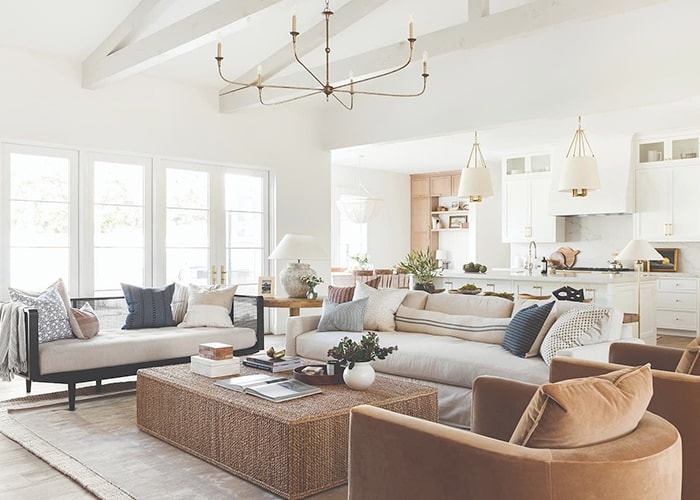 an all-white contemporary living room with natural-toned accents