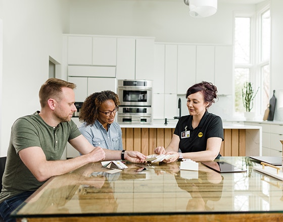 a Pella sales representative is showing a couple swatches of features and options