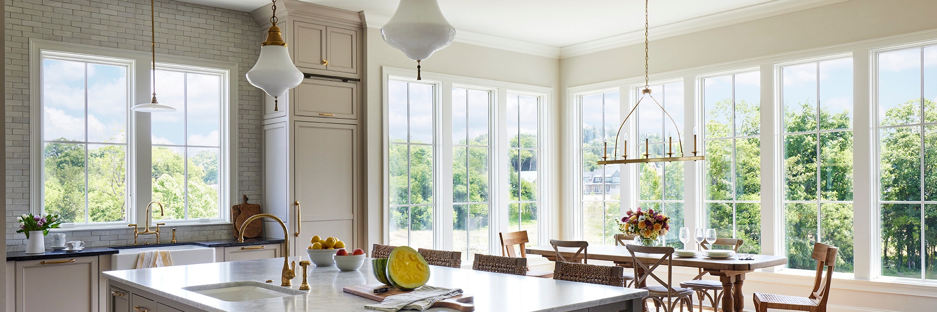 White casement windows open up dining room space in kitchen.