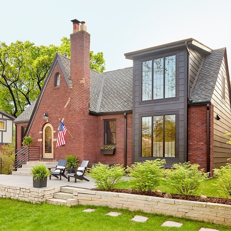 a brick tudor home with new renovations and windows