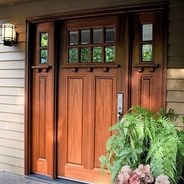Mahogany stained wood front door with sidelights on craftsman home