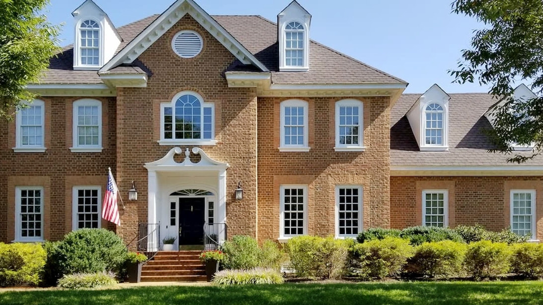 Henrico home showcasing newly installed Pella white double-hung windows.