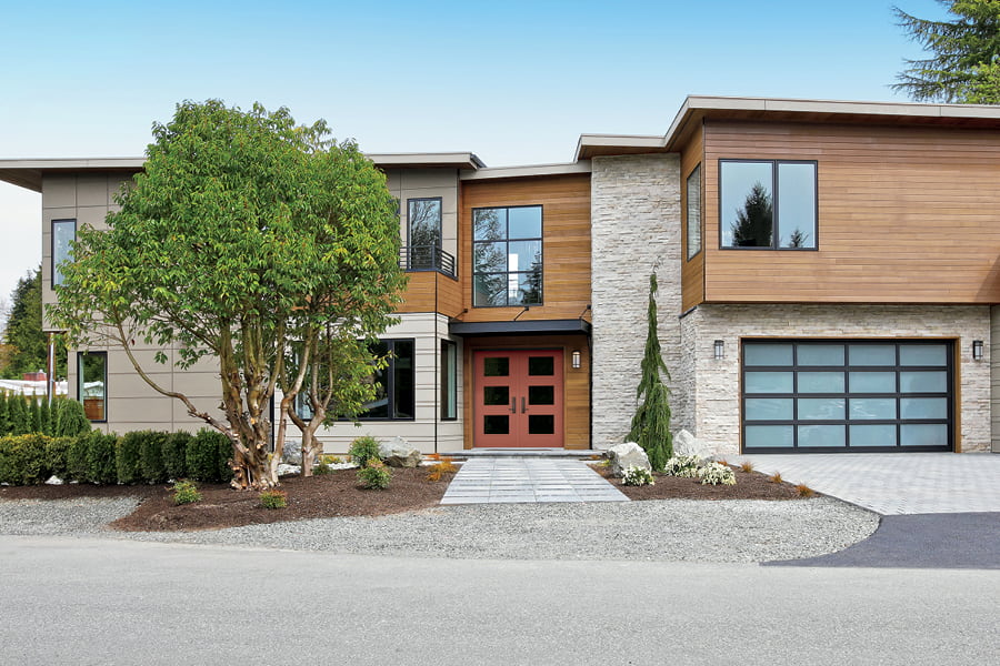Contemporary two-story home with red double front door