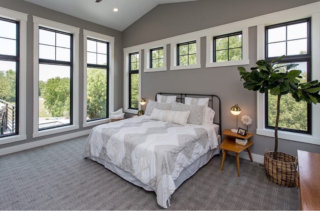 contemporary bedroom with black window frames and white wood trim