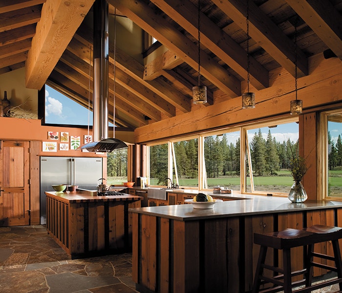 An all-wood rustic kitchen with square awning windows