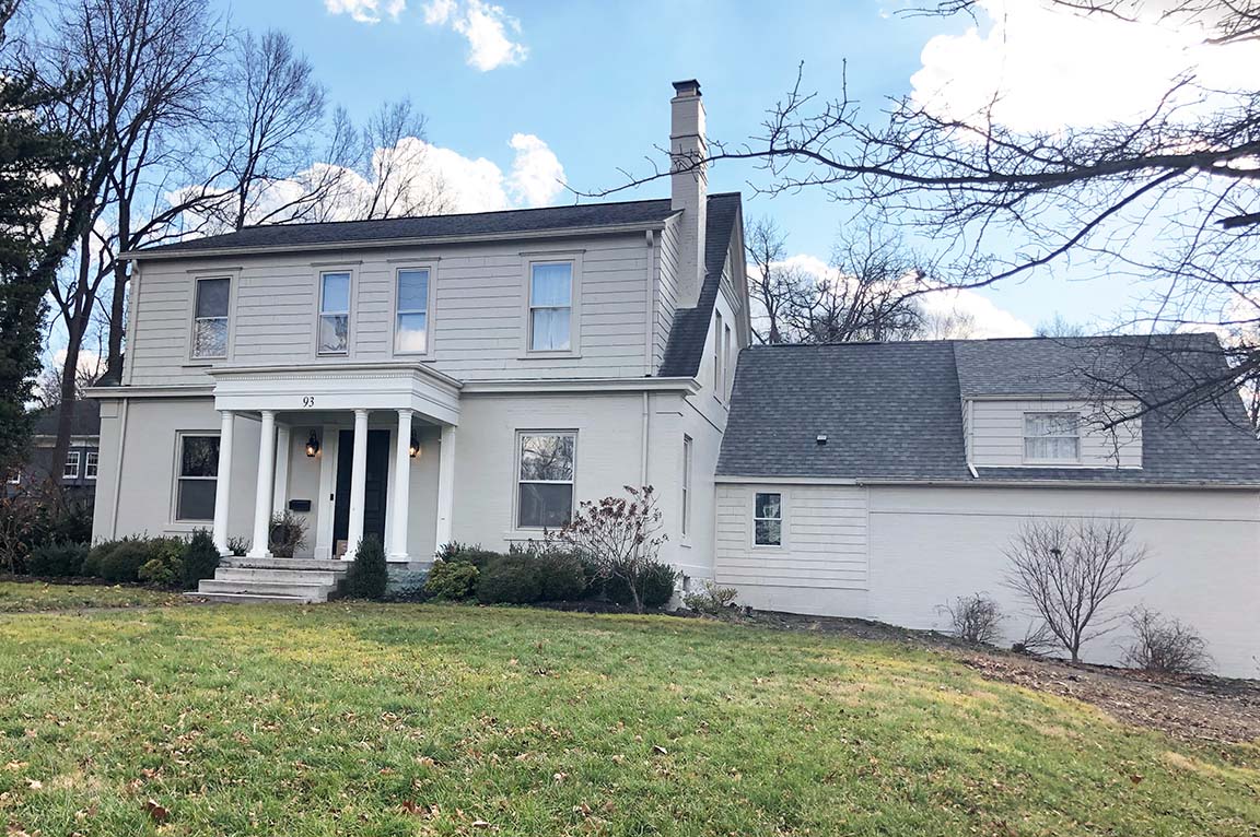 Two-story white home with a porch and columns, part of the Worthington Home Replacement project.