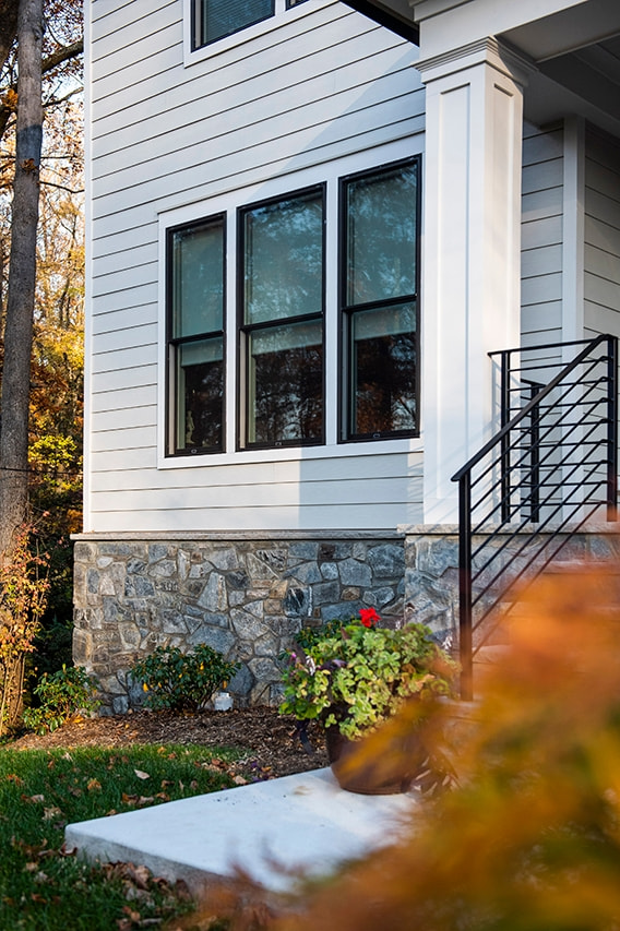 Brown windows on modern house with stone foundation in Falls Church home. 
