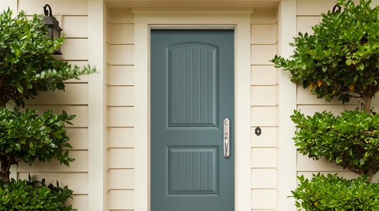 Cheyenne Blue Ash Fiberglass Entry Door of White Paneled Home