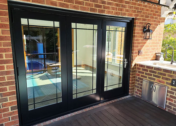 Black bifold doors on patio of Virginia Beach home.