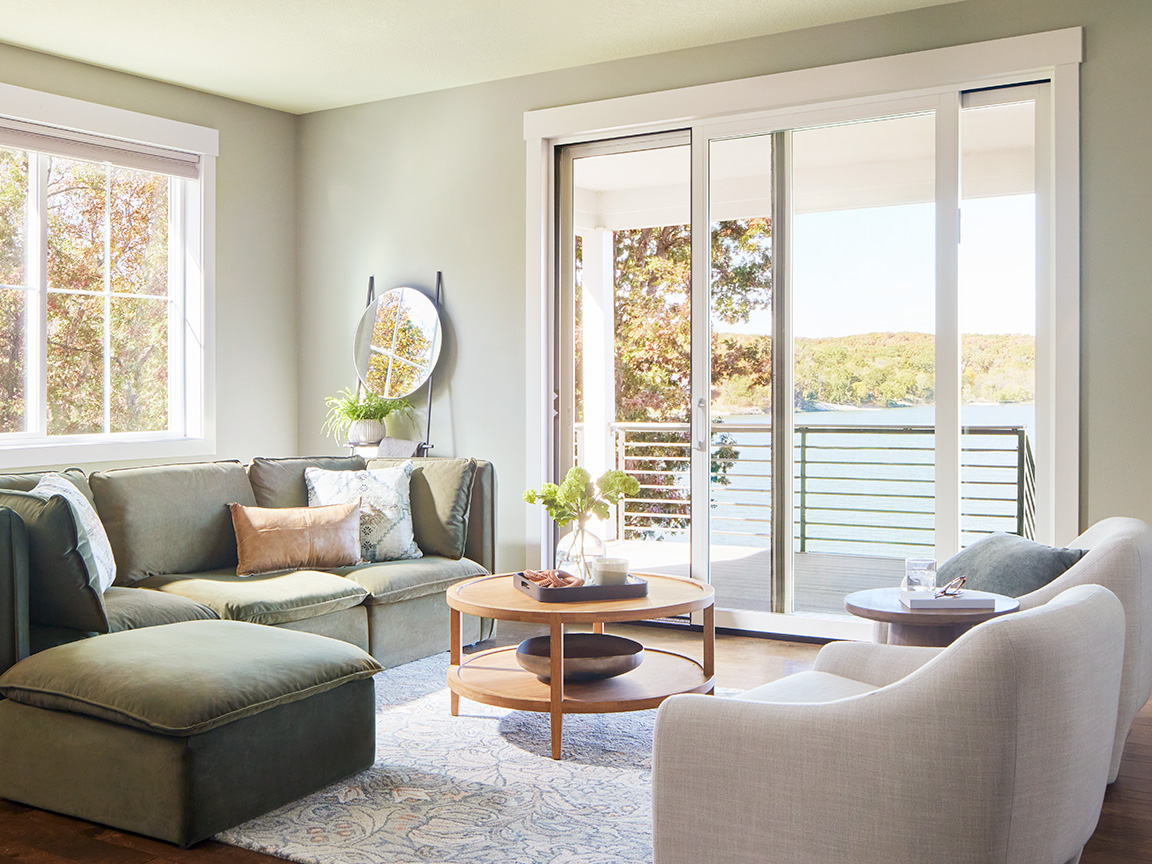 A traditional living with sliding patio doors open to scenic lake views.