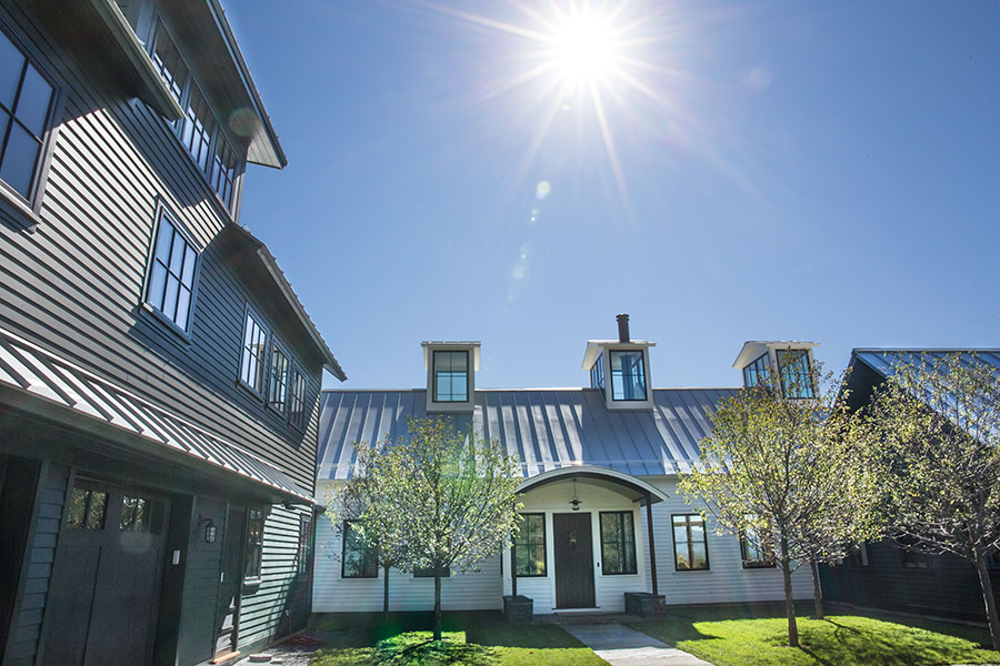Sunny view of a Berkshire farmhouse with newly installed Pella wood windows.