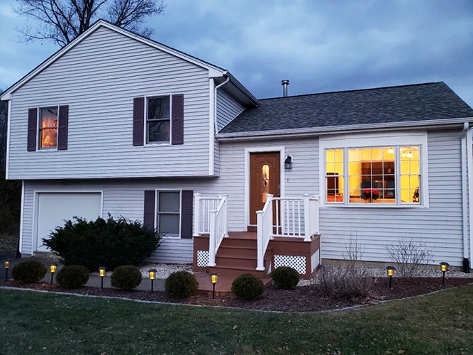 Curbside view of an Essex home with a replacement Pella bay window.