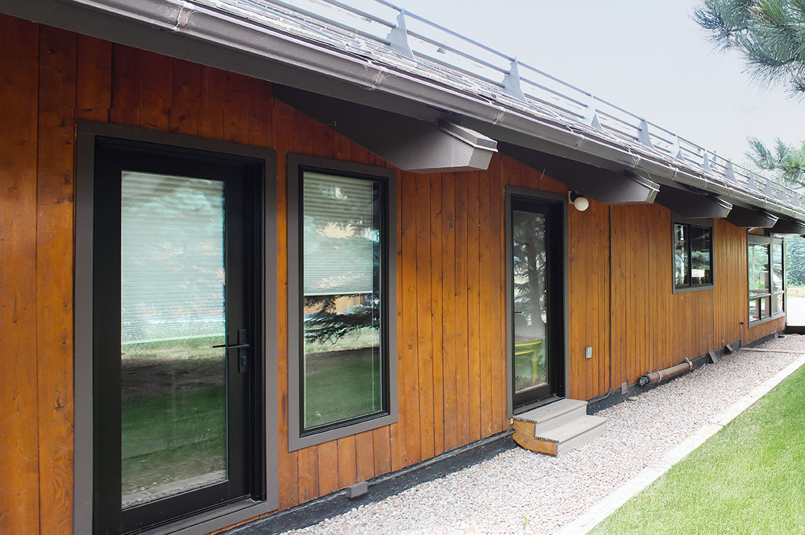 Aspen Energy Efficient home with wood siding and a modern front door.