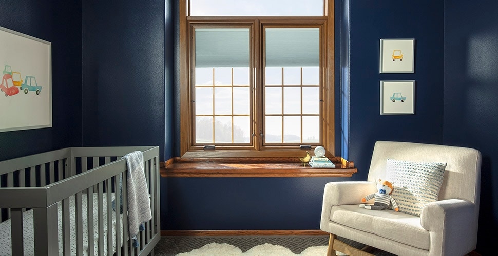 dark blue nursery with two wood casement windows