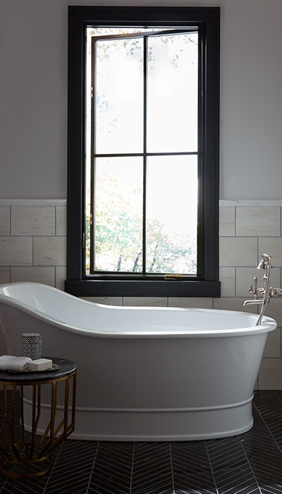 white soaking tub black casement window