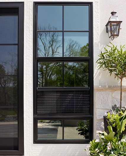 A black window with a hidden screen on a white home.