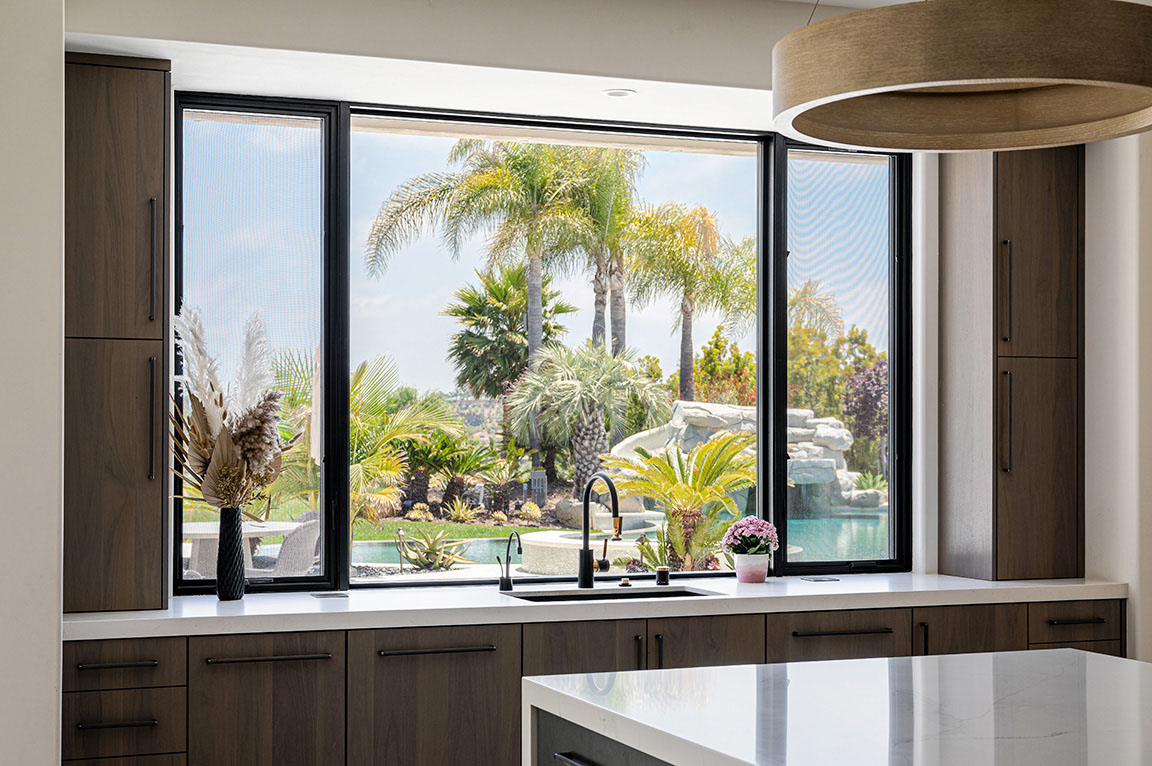 Black window in Encinitas kitchen highlighting beautiful outside view.