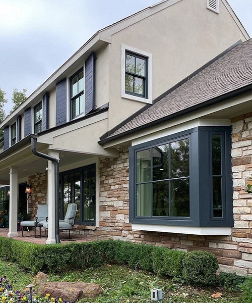 exterior of home after new pella black windows