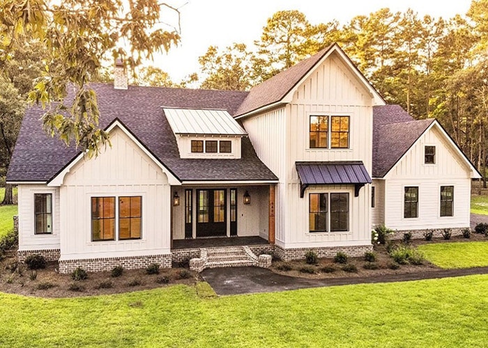 large white farmhouse-style home with dormer windows