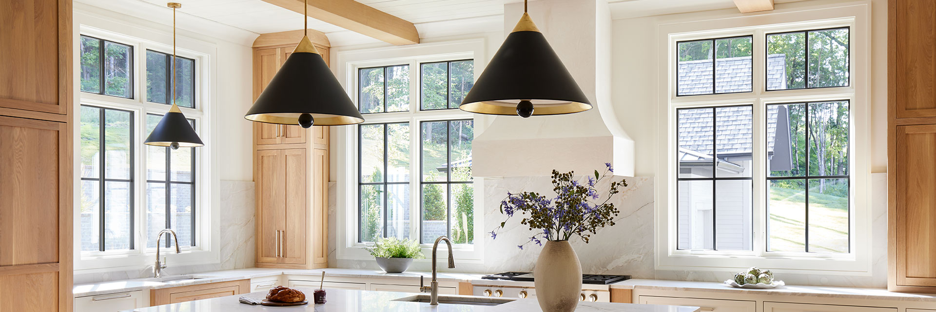 contemporary kitchen with bucket lights and black windows