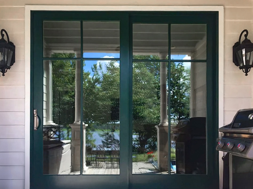 Charles city patio with newly installed Pella green sliding door.