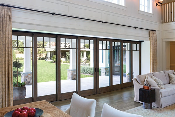 An 8-panel multi-slide door bridges the wall between the interior and exterior of a home.