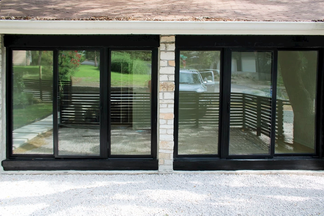 Exterior view of black sliding glass doors for Austin home.