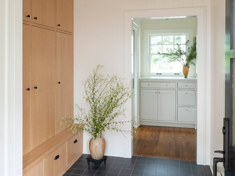 a view into a laundry room featuring a large white Pella double-hung window