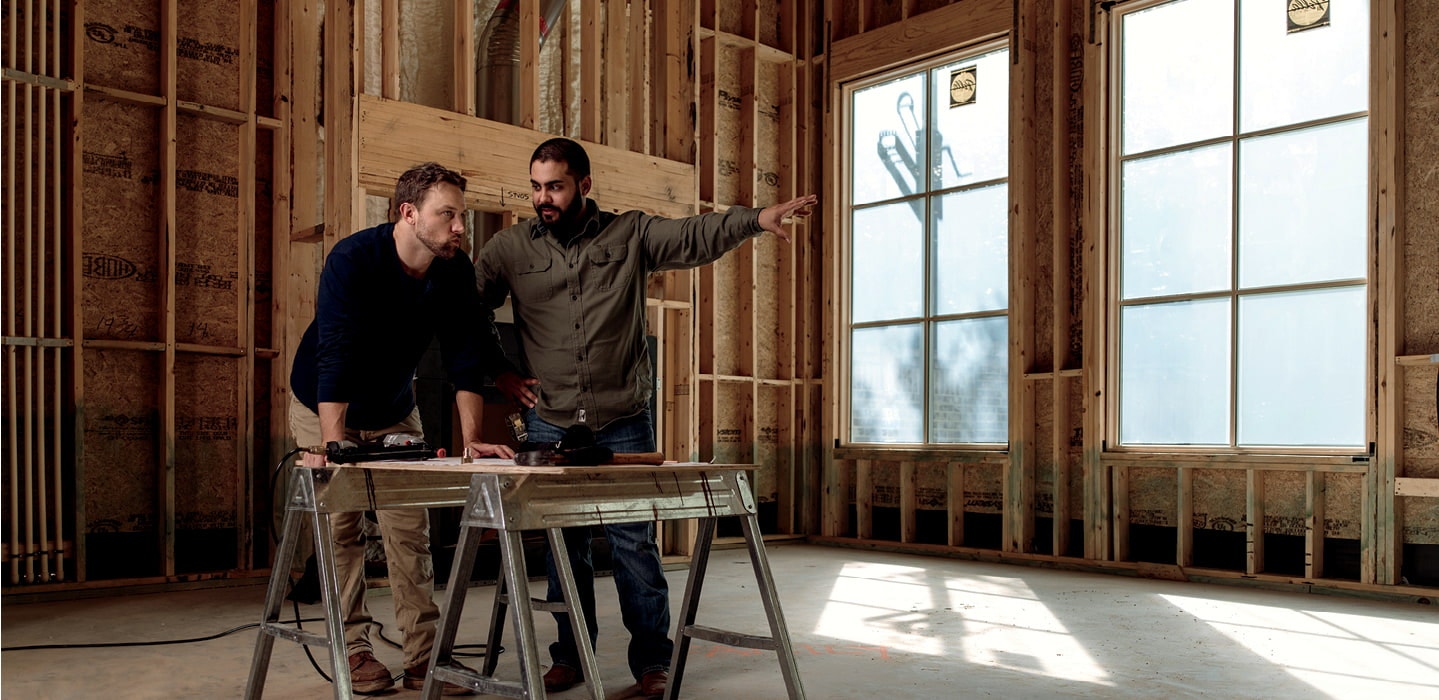 two construction workers discussing new construction pella windows