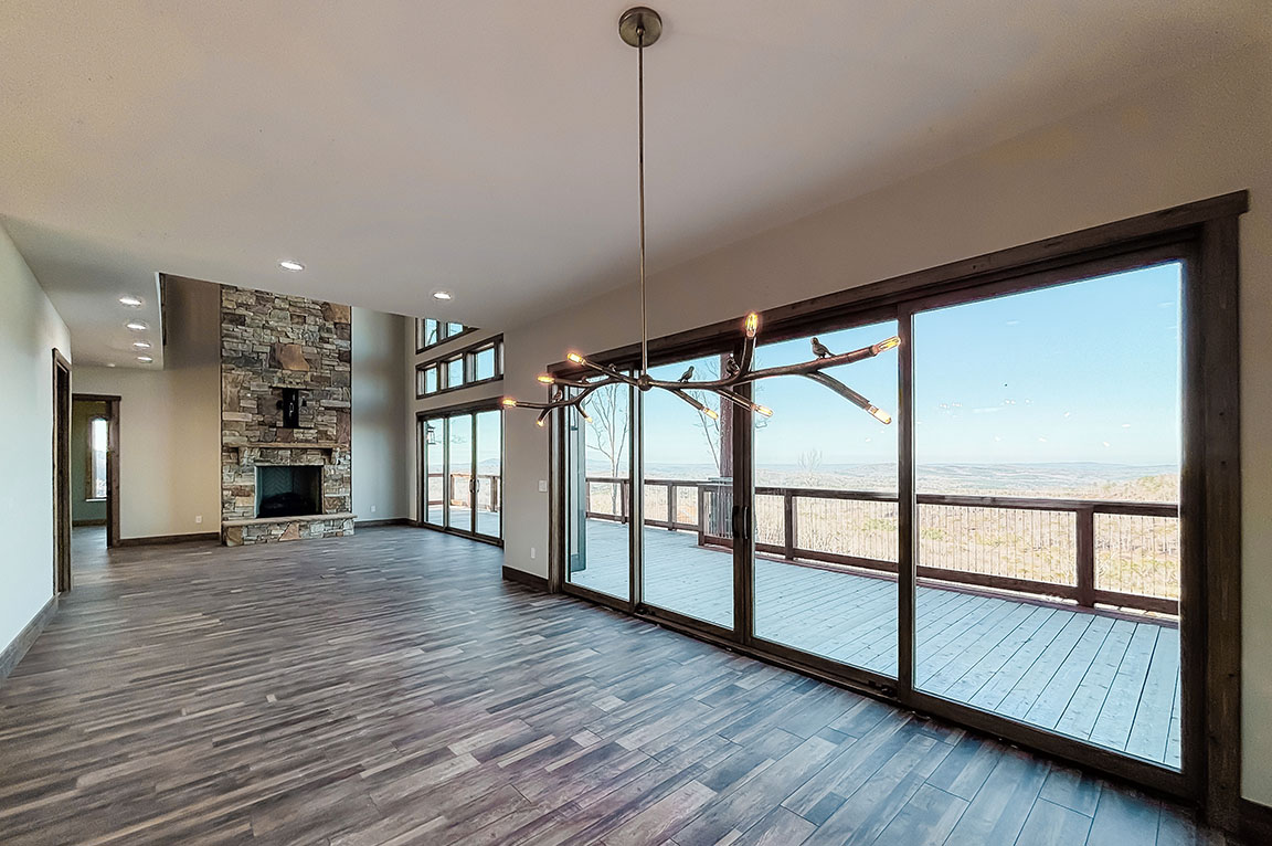 Open living area with sliding glass doors and deck views.