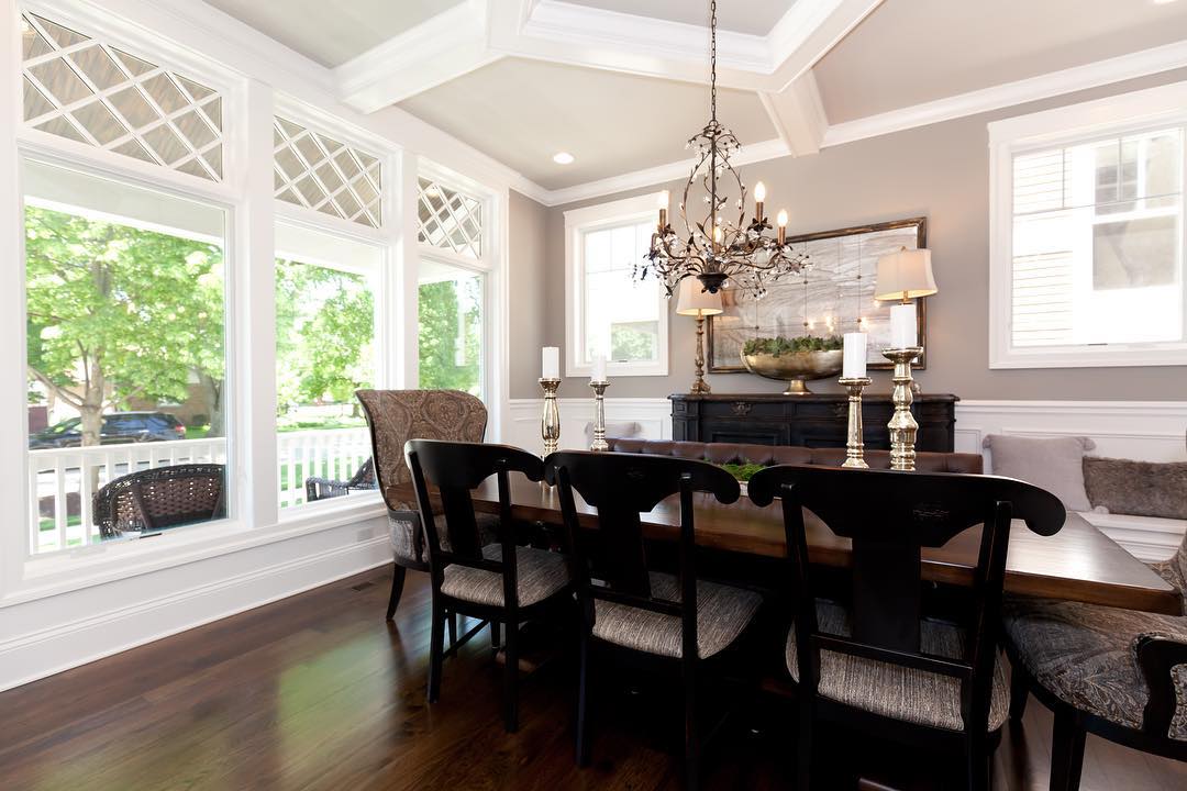 white casement windows and dark wood furniture in traditional dining room