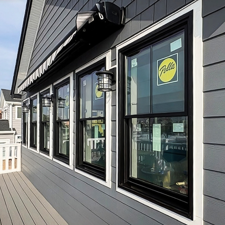 Black Pella windows installed on modern home exterior