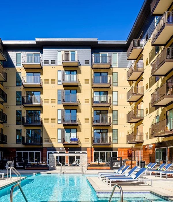 Poolside at a newly constructed apartment building in Bloomington with modern windows.
