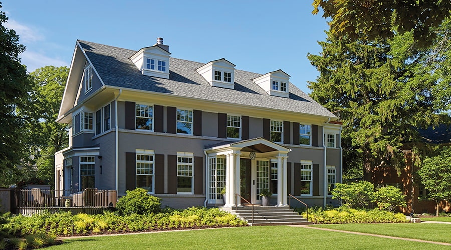 Large colonial home exterior with traditional white windows