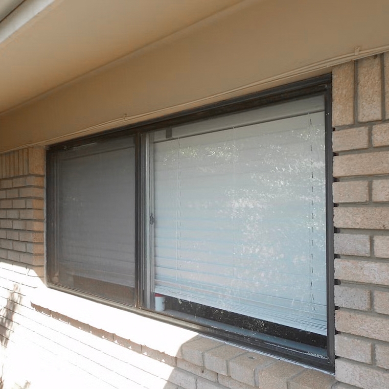 Outdated bedroom casement window on Tulsa home.