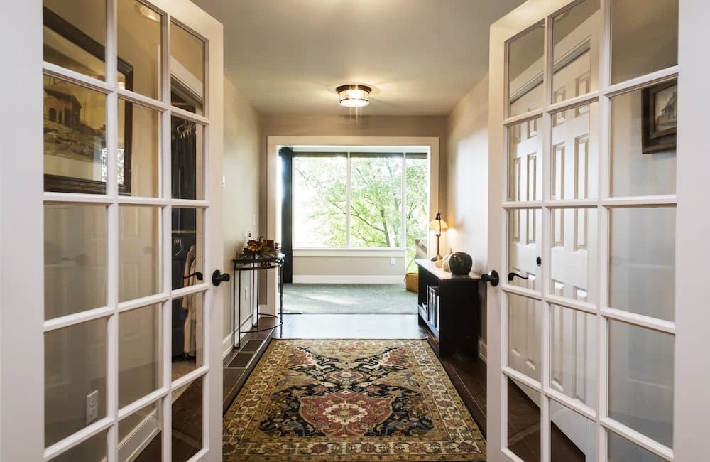 Interior hallway of Strasburg home highlighting black-framed windows.