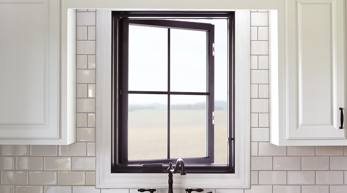 a single black casement window with custom grilles over a kitchen sink
