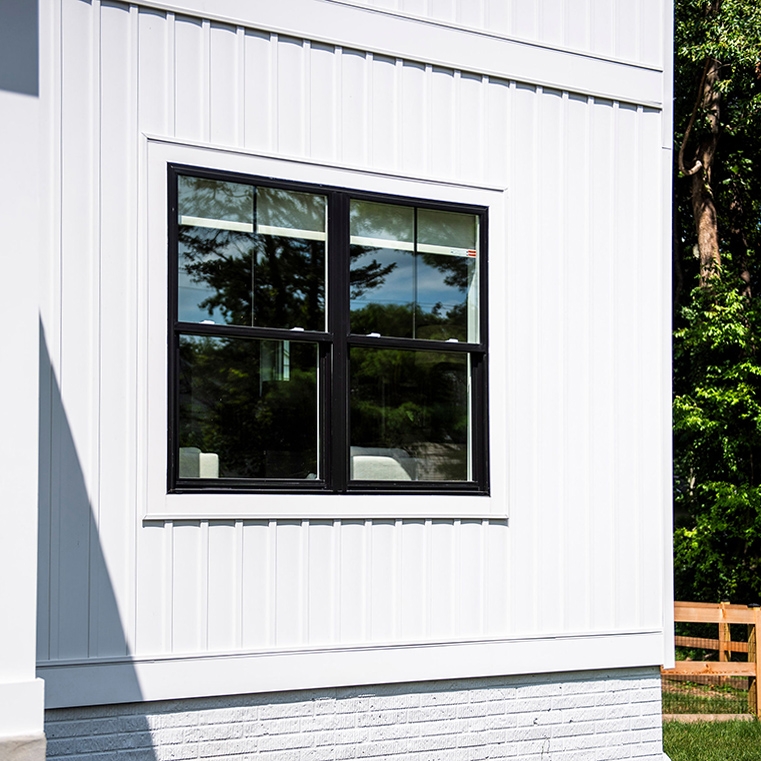 Grilles between the glass on exterior of  Annapolis farmhouse style home. 
