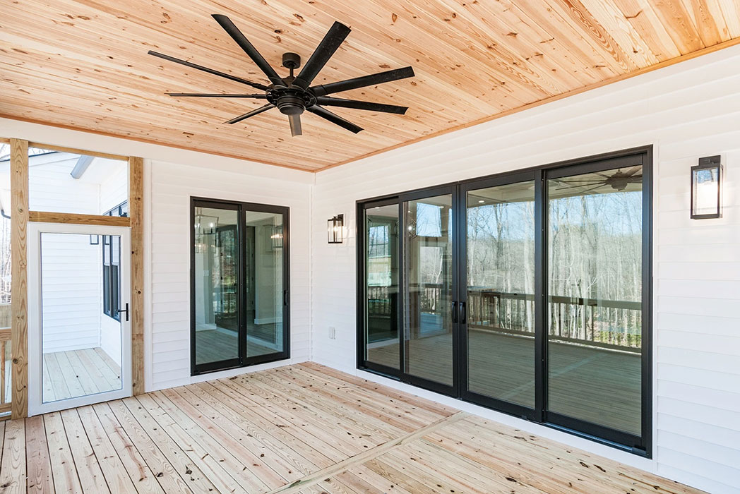 A newly constructed outdoor porch in Midlothian with black 4-panel patio doors.