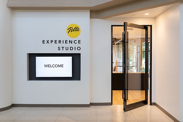 A Pella VIP showroom entrance with a TV monitor and expansive glass entryway