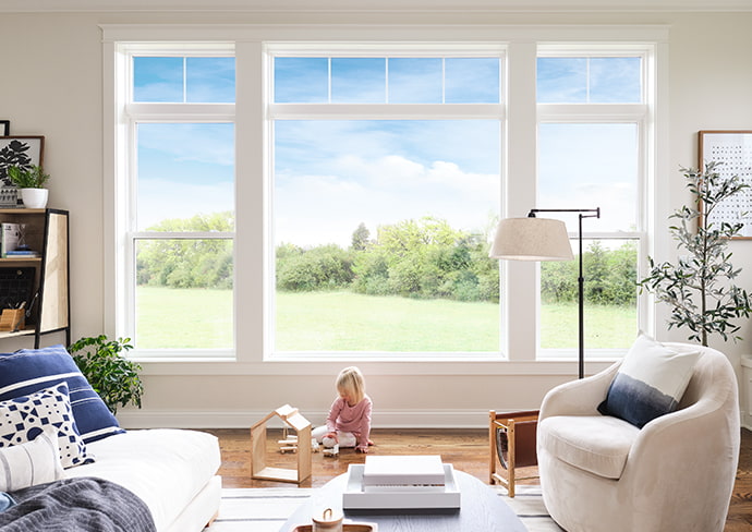 child playing with toys below a configured group of vinyl 250 series windows