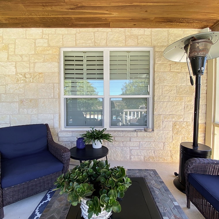 A cozy patio area featuring blue chairs,, illustrating a window and patio upgrade.