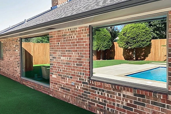 two large picture windows on an Oklahoma brick home